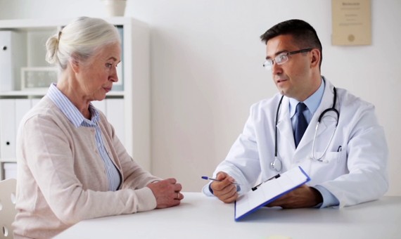 A doctor talking to an old woman