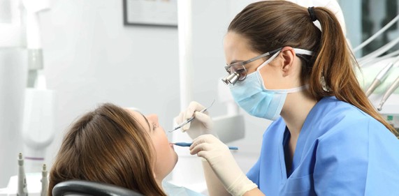 A dentist checking teeth