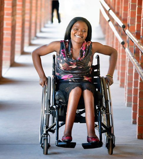 A black woman on a wheelchair